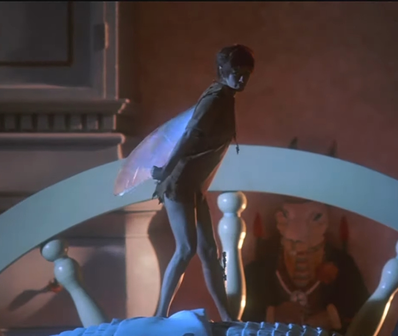 alt="Julia Roberts as Tinkerbell stands in front of Peter Pan in Hook"