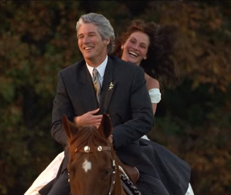 alt="Julia Roberts and Richard Gere ride on a horse in Runaway Bride"