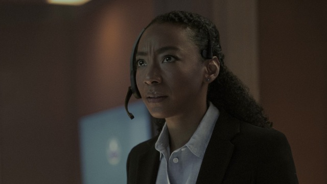 Betty Gabriel as Elizabeth Wright with a headset on looking concerned