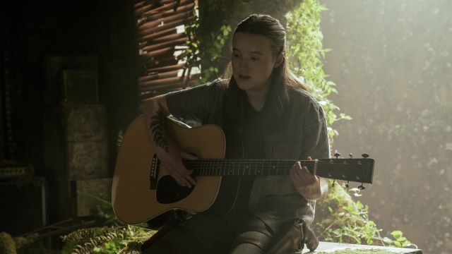 alt="Ellie playing the guitar in seattle music shop.jpg"