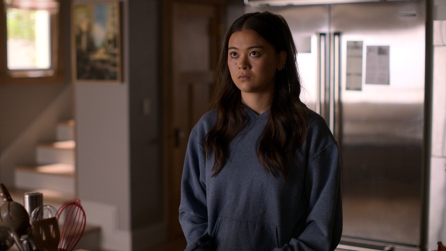 alt="Lukita Maxwell as Alice Laird standing in the kitchen in Shrinking"